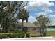 Charming building surrounded by trees and lush landscaping near the water at 8705 Village Green Blvd, Clermont, FL 34711