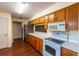 View of the kitchen with wood cabinets, white countertops, and stainless steel refrigerator at 8705 Village Green Blvd, Clermont, FL 34711