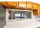 Kitchen counter view into spacious living room with vaulted ceilings and abundant natural light at 8705 Village Green Blvd, Clermont, FL 34711