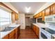 Bright kitchen featuring wood cabinets, laminate countertops, and stainless steel appliances at 8705 Village Green Blvd, Clermont, FL 34711