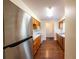 Bright kitchen featuring wood cabinets, white countertops, stainless steel refrigerator, and laminate wood flooring at 8705 Village Green Blvd, Clermont, FL 34711