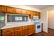 A kitchen featuring wood cabinets, white countertops, and a view through to an adjacent room at 8705 Village Green Blvd, Clermont, FL 34711