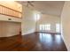 Expansive living room with vaulted ceiling, wood floors, and access to the outdoor patio at 8705 Village Green Blvd, Clermont, FL 34711