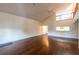 Spacious living room with high ceilings, wood floors, and an open layout to the kitchen at 8705 Village Green Blvd, Clermont, FL 34711