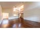 Open concept living room with high ceilings, wood floors, and a view to the second-floor balcony at 8705 Village Green Blvd, Clermont, FL 34711