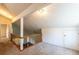 Bright loft area featuring neutral carpet, fresh paint, wood railing, and direct access to another room at 8705 Village Green Blvd, Clermont, FL 34711