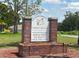 Green Valley Country Club Bar & Grill sign with brick columns and landscaped surroundings at 8705 Village Green Blvd, Clermont, FL 34711