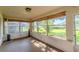 Sunroom with tile flooring, lots of windows and a view of the home's backyard at 8705 Village Green Blvd, Clermont, FL 34711