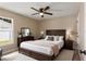 Comfortable bedroom with a ceiling fan, a large bed, and matching dark wood furniture at 919 Cr 482C, Lake Panasoffkee, FL 33538