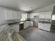 Modern kitchen featuring white cabinets and granite countertops, ready for appliances at 919 Cr 482C, Lake Panasoffkee, FL 33538