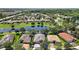 Aerial view of home showcasing lush landscaping, and proximity to a scenic pond at 926 Wood Briar Loop, Sanford, FL 32771