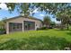 Spacious backyard featuring a screened-in porch and a fenced-in grassy area at 926 Wood Briar Loop, Sanford, FL 32771