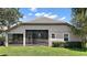 Exterior view of the backyard with a screen enclosed lanai and manicured shrubbery at 926 Wood Briar Loop, Sanford, FL 32771