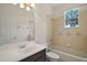Bathroom with a tub, toilet, dark vanity with a sink, and a mirror at 926 Wood Briar Loop, Sanford, FL 32771