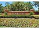 The Lake Forest community entrance sign surrounded by colorful flowers and manicured shrubs at 926 Wood Briar Loop, Sanford, FL 32771