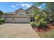 Charming single-story home featuring a paver driveway, three-car garage and manicured landscaping at 926 Wood Briar Loop, Sanford, FL 32771