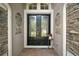 Elegant double front doors with glass panels, flanked by decorative wall accents and stone details at 926 Wood Briar Loop, Sanford, FL 32771