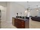 Kitchen island features dark granite countertops, sink, stainless steel dishwasher, and ample cabinet space at 926 Wood Briar Loop, Sanford, FL 32771
