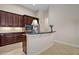Kitchen has dark wood cabinetry, granite counters, stainless appliances, and an island with seating at 926 Wood Briar Loop, Sanford, FL 32771
