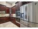 Traditional kitchen featuring stainless steel appliances, custom dark wood cabinetry, and granite countertops at 926 Wood Briar Loop, Sanford, FL 32771
