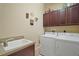 Functional laundry room includes washer, dryer, utility sink, and storage cabinets at 926 Wood Briar Loop, Sanford, FL 32771