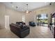 Bright and open living room with tiled floors, comfortable seating, and sliding glass doors to the outdoors at 926 Wood Briar Loop, Sanford, FL 32771