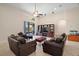 Cozy living room with tiled floors, comfortable seating, a large TV, and access to the outdoor patio at 926 Wood Briar Loop, Sanford, FL 32771