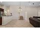 Open-concept living area with tile floors, neutral walls, and open kitchen with dark cabinets at 926 Wood Briar Loop, Sanford, FL 32771