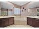Bathroom featuring dual sinks, mirrors, dark cabinetry, tile flooring, and a separate tub at 926 Wood Briar Loop, Sanford, FL 32771
