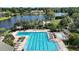 Resort-style community pool with lounge chairs, umbrellas, and well-maintained landscaping at 926 Wood Briar Loop, Sanford, FL 32771