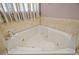 Close up of a soaking tub with tile surround and decorative tile accents at 926 Wood Briar Loop, Sanford, FL 32771