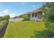 Large backyard featuring lush green grass and a secure fence at 1539 Osprey View Dr, Apopka, FL 32703