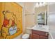 Bright bathroom with neutral colors and a Winnie the Pooh shower curtain at 1539 Osprey View Dr, Apopka, FL 32703