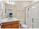 Bright bathroom featuring a single sink vanity, a shower with glass doors, and a view into the bedroom at 1539 Osprey View Dr, Apopka, FL 32703