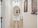 Half bathroom featuring pedestal sink and soft decor at 1539 Osprey View Dr, Apopka, FL 32703