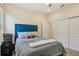 A bedroom with cool neutral paint, a ceiling fan, and a blue headboard at 1539 Osprey View Dr, Apopka, FL 32703