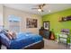 Bedroom with guitar, bed, and artwork at 1539 Osprey View Dr, Apopka, FL 32703