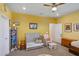 Cozy bedroom with twin bed, rocker, and decor at 1539 Osprey View Dr, Apopka, FL 32703