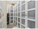 Walk-in closet with frosted sliding door fronts and warm brown leather handle detailing at 1539 Osprey View Dr, Apopka, FL 32703