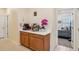 A coffee bar with wood cabinets and white countertops, with a view into a bedroom at 1539 Osprey View Dr, Apopka, FL 32703