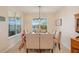 Bright dining room features a modern chandelier, neutral tones, and a large window offering an abundance of natural light at 1539 Osprey View Dr, Apopka, FL 32703