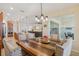 Elegant dining area open to living room, featuring a large table and view of outdoor space at 1539 Osprey View Dr, Apopka, FL 32703