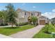 Beautiful two-story home with well-manicured landscaping, a brick driveway, and inviting curb appeal at 1539 Osprey View Dr, Apopka, FL 32703
