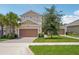 Charming two-story home featuring a three-car garage, well-maintained lawn, and inviting curb appeal at 1539 Osprey View Dr, Apopka, FL 32703