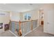 Well lit second story hallway with carpet flooring and decorative wrought iron banister at 1539 Osprey View Dr, Apopka, FL 32703