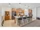 Spacious kitchen with stainless steel appliances, wooden cabinets, granite countertops, and a stylish breakfast bar with seating at 1539 Osprey View Dr, Apopka, FL 32703