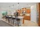 Open-concept kitchen featuring a large island, stainless appliances, wooden cabinets, and seamless flow into the dining area at 1539 Osprey View Dr, Apopka, FL 32703