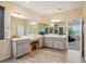 Spacious bathroom boasts dual sinks, a makeup vanity, a tiled shower, and wood-look floors at 1539 Osprey View Dr, Apopka, FL 32703