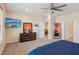 Comfortable main bedroom with ceiling fan, carpet floors, and large window offering plenty of natural light at 1539 Osprey View Dr, Apopka, FL 32703