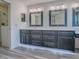Bright bathroom showcasing a modern double vanity with grey cabinets, white countertops, and sleek lighting at 1016 Eagles Lndg, Leesburg, FL 34748